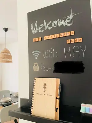 a blackboard with a welcome sign on a wall at HAY Apartment Bled in Bled