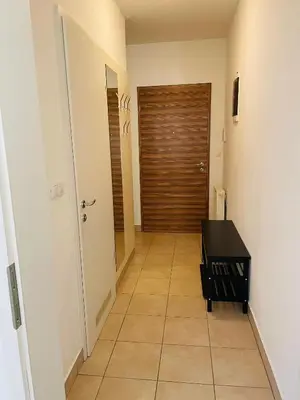 a hallway with a door and a tiled floor at HAY Apartment Bled in Bled