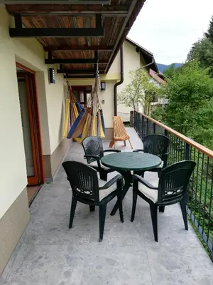 a patio with a table and chairs on a balcony at Siesta apartment Bled in Bled