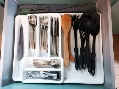 a white tray with utensils in a drawer at Siesta apartment Bled in Bled