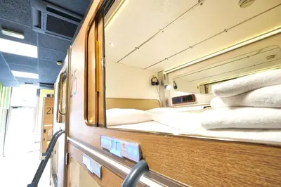a small room with two beds on a train at Ljubljana Capsule Hostel in Ljubljana