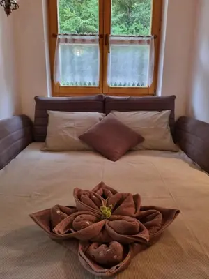 a large bed with a flower on top of it at Cottage by the pond Pavel in Šmarje pri Jelšah