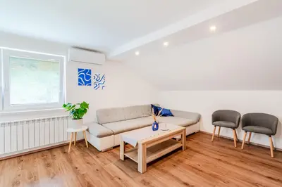 a living room with a couch and two chairs at Apartmaji Mouse in Bovec