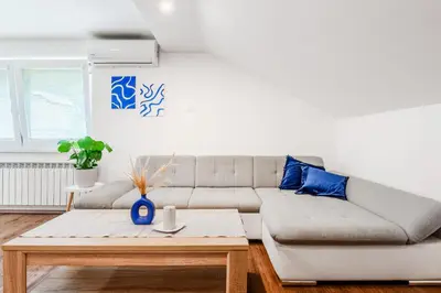 a living room with a couch and a coffee table at Apartmaji Mouse in Bovec