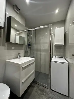 a bathroom with a shower and a sink and a toilet at Vivo Bovec in Bovec