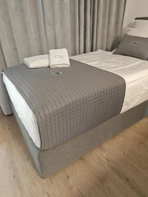 a bed with two pillows on top of it at Vivo Bovec in Bovec