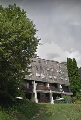 a large building with a tree in front of it at Vivo Bovec in Bovec