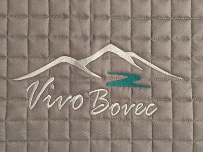 a sign that says v two bone on a quilt at Vivo Bovec in Bovec