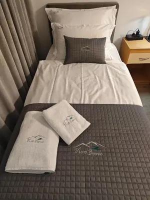 a bed with two towels on top of it at Vivo Bovec in Bovec