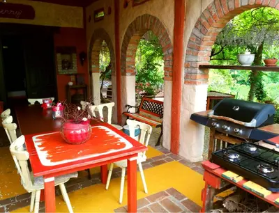 a table and chairs in a kitchen with a stove at Krasberry Ježev brlog in Komen