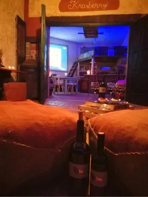 two bottles of wine sitting on two beds in a room at Krasberry Ježev brlog in Komen