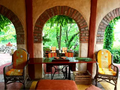 an outdoor patio with a table and chairs at Krasberry Ježev brlog in Komen