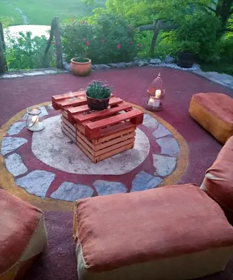 a patio with a table and a potted plant at Krasberry Ježev brlog in Komen