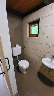 a bathroom with a toilet and a sink at Glamping Fikfak in Bled