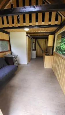 a room with a couch and a table in a room at Glamping Fikfak in Bled