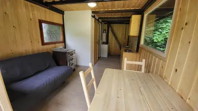 a living room with a couch and a table at Glamping Fikfak in Bled