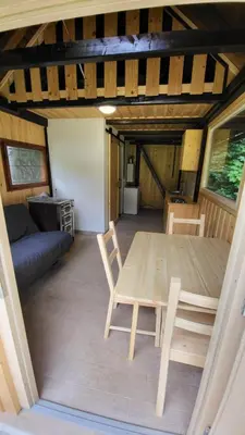 a dining room with a table and chairs in a room at Glamping Fikfak in Bled