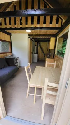 a dining room with a table and chairs in a room at Glamping Fikfak in Bled