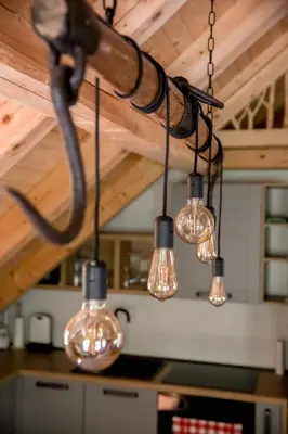 a group of lights hanging from a ceiling at Apartma Mlekuž in Bovec