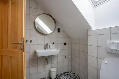 a bathroom with a sink and a mirror at Corner House Apartments near Lake Bled in Radovljica