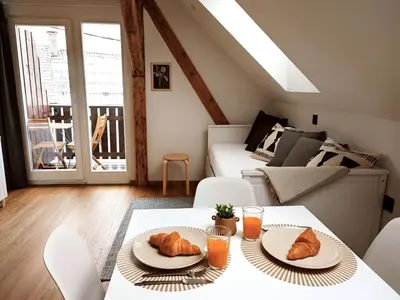a living room with a table and two plates of croissants at Corner House Apartments near Lake Bled in Radovljica