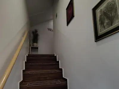 a stairway with brown steps and a picture on the wall at L&G ROOMS in Ljubljana