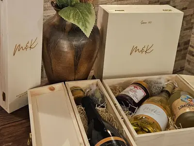 a box filled with bottles of wine next to a vase at Gozdarjeva hiška M&K in Dobrovnik