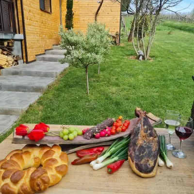 a tray of vegetables and bread on a table at Gozdarjeva hiška M&K in Dobrovnik