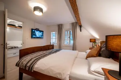 a bedroom with a bed and a tv on the wall at House Leska in Kranjska Gora