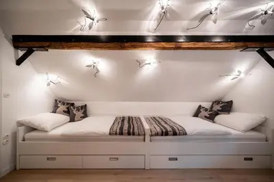 a room with a bed with lights on the wall at House Leska in Kranjska Gora