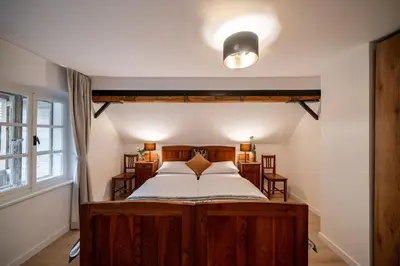 a bedroom with a wooden bed and a window at House Leska in Kranjska Gora