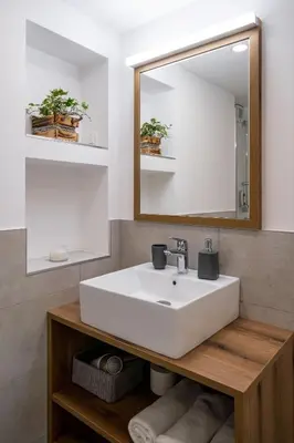 a bathroom with a white sink and a mirror at House Leska in Kranjska Gora