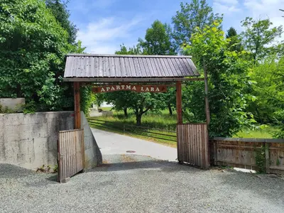 an entrance to a park with a wooden gate at Apartma Lara in Bled