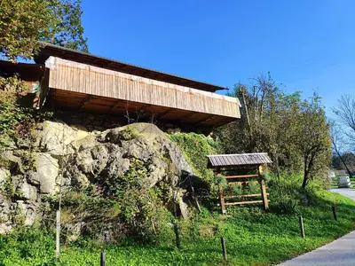 a bench sitting in front of a building at Apartma Lara in Bled