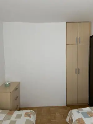a bedroom with two beds and a dresser at Bee's Place Holiday Home Kranjska Gora in Kranjska Gora