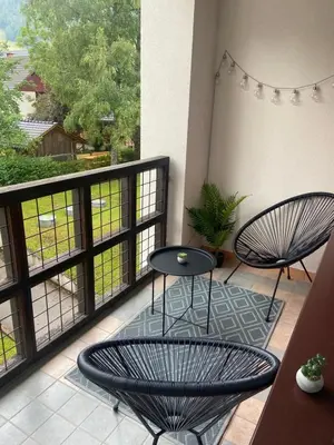a balcony with two chairs and a table at Bee's Place Holiday Home Kranjska Gora in Kranjska Gora