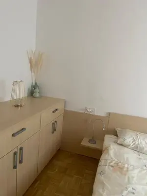a bedroom with a bed and a desk with a lamp at Bee's Place Holiday Home Kranjska Gora in Kranjska Gora