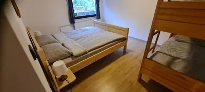 a bedroom with two bunk beds and a window at Apartma Vidic in Gozd Martuljek
