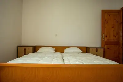 a large bed with two pillows on top of it at Apartma Na skdnu in Dutovlje