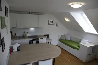 a kitchen with a table and a couch in a room at Family apartment on Repečnik farm in Gorje, Bled in Zgornje Gorje