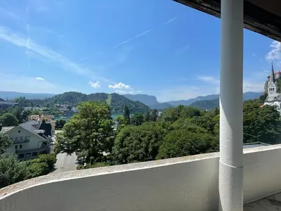 a balcony with a view of a city and mountains at Apartment Lucy, Bled in Bled
