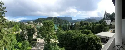 a view of a town with a river and mountains at Apartment Lucy, Bled in Bled