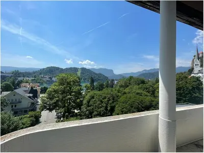a balcony with a view of a town and mountains at Apartment Lucy, Bled in Bled