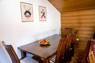 a dining room table with a bowl of fruit on it at Apartma Kamra15 in Mežica