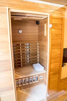 a sauna in a room with wooden walls at Apartma Kamra15 in Mežica