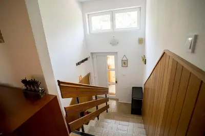 a hallway with stairs and a skylight in a house at Apartma Kamra15 in Mežica
