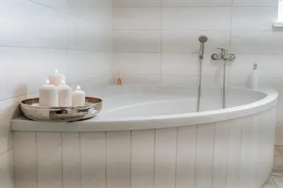 a bathroom with a tub with candles on a counter at Villa Cerkniško jezero in Cerknica