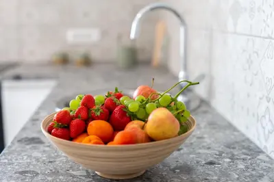 a bowl of fruit on a counter in a kitchen at Villa Cerkniško jezero in Cerknica