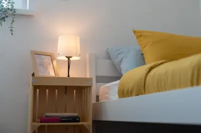 a bedroom with a bed with a lamp and a night stand at Villa Cerkniško jezero in Cerknica