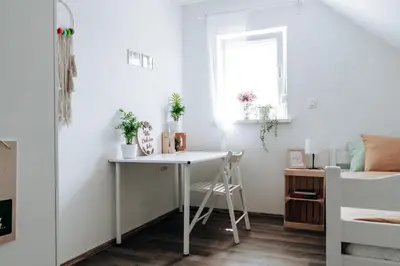 a small room with a desk and a bed at Villa Cerkniško jezero in Cerknica